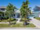 Charming blue home with a metal roof, inviting porch, and lush landscaping at 426 Islebay Dr, Apollo Beach, FL 33572