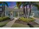 Charming light blue home featuring a welcoming front porch, lush landscaping, and a well-maintained lawn at 426 Islebay Dr, Apollo Beach, FL 33572