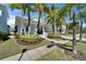 Charming light blue home featuring a welcoming front porch, lush landscaping, and a well-maintained lawn at 426 Islebay Dr, Apollo Beach, FL 33572