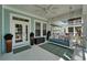 Charming front porch featuring a swing, white pillars, and ample seating space at 426 Islebay Dr, Apollo Beach, FL 33572