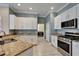 Stylish kitchen with granite countertops, stainless steel appliances, and views to the laundry room at 426 Islebay Dr, Apollo Beach, FL 33572