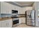 Well-equipped kitchen with white cabinets, stainless steel appliances, and granite countertops at 426 Islebay Dr, Apollo Beach, FL 33572
