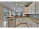 Open kitchen with granite counters, stainless appliances, and a view of the living space at 426 Islebay Dr, Apollo Beach, FL 33572