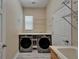 Functional laundry room featuring washer, dryer, storage and utility sink at 426 Islebay Dr, Apollo Beach, FL 33572