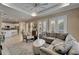 Comfortable living room with neutral tones, large sofa, and view to the outdoor patio at 426 Islebay Dr, Apollo Beach, FL 33572