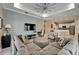 Inviting living room with a large gray couch, decorative pillows, and a modern ceiling fan at 426 Islebay Dr, Apollo Beach, FL 33572