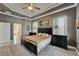 Comfortable main bedroom featuring a tray ceiling, and an ensuite bathroom at 426 Islebay Dr, Apollo Beach, FL 33572