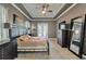 Well-appointed main bedroom with a tray ceiling, dark wood furniture and backyard views at 426 Islebay Dr, Apollo Beach, FL 33572