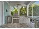 Well-equipped outdoor kitchen, featuring a built-in grill, granite countertops, and ample space for preparing meals at 426 Islebay Dr, Apollo Beach, FL 33572