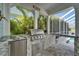 Outdoor kitchen area featuring a grill and counter space, perfect for entertaining at 426 Islebay Dr, Apollo Beach, FL 33572