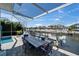 Screened patio overlooking canal with a dining table, outdoor shower, a boat lift and great views at 426 Islebay Dr, Apollo Beach, FL 33572
