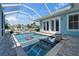 Inviting backyard pool area, featuring sun loungers and a serene setting, perfect for relaxation and enjoying the outdoors at 426 Islebay Dr, Apollo Beach, FL 33572