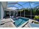 Serene backyard pool with mature landscaping and relaxing seating, perfect for enjoying a refreshing swim and lounging at 426 Islebay Dr, Apollo Beach, FL 33572