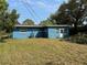 Exterior view of a blue home with a spacious backyard at 4316 70Th N Ave, Pinellas Park, FL 33781