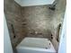 Bathroom featuring a tiled shower over tub with grab bars at 4316 70Th N Ave, Pinellas Park, FL 33781