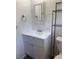 Updated bathroom features white vanity with storage, brushed nickel hardware and a framed mirror at 4316 70Th N Ave, Pinellas Park, FL 33781