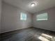 Bright bedroom with laminate flooring and two windows at 4316 70Th N Ave, Pinellas Park, FL 33781