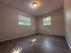 Bedroom featuring gray vinyl floors, two windows and light neutral paint at 4316 70Th N Ave, Pinellas Park, FL 33781