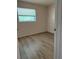 Cozy bedroom with laminate flooring and natural light from the window at 4316 70Th N Ave, Pinellas Park, FL 33781