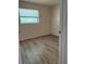 Simple bedroom with new flooring and a window at 4316 70Th N Ave, Pinellas Park, FL 33781