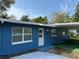 Charming blue home exterior featuring a well-maintained lawn and carport at 4316 70Th N Ave, Pinellas Park, FL 33781