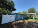 Charming exterior of a blue home features a fenced yard and covered parking at 4316 70Th N Ave, Pinellas Park, FL 33781