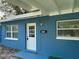 Exterior view of a home entrance featuring a vibrant blue color at 4316 70Th N Ave, Pinellas Park, FL 33781