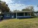 Exterior showcases a single-story blue home with a covered porch and well-maintained lawn at 4316 70Th N Ave, Pinellas Park, FL 33781