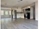 Open-concept kitchen boasts stainless steel appliances and light gray backsplash overlooking the living space at 4316 70Th N Ave, Pinellas Park, FL 33781