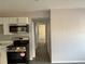 Modern kitchen with stainless steel appliances and white cabinets along a hallway at 4316 70Th N Ave, Pinellas Park, FL 33781