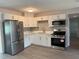 Modern kitchen featuring white cabinets, stainless steel appliances, and beautiful gray backsplash at 4316 70Th N Ave, Pinellas Park, FL 33781