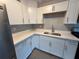Stylish kitchen featuring white cabinets, quartz countertops, stainless steel sink, and gray subway tile backsplash at 4316 70Th N Ave, Pinellas Park, FL 33781