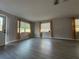 Bright living room featuring gray vinyl floors, curtains and a window overlooking the front yard at 4316 70Th N Ave, Pinellas Park, FL 33781