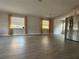 Spacious living room with wood-look floors, curtains, and natural light, next to the kitchen at 4316 70Th N Ave, Pinellas Park, FL 33781