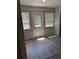 Sunlit room with modern flooring, a door to the exterior and two windows at 4316 70Th N Ave, Pinellas Park, FL 33781