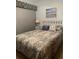 Relaxing bedroom with coastal-themed decor, including a patterned quilt and seaside artwork at 4556 Blossom Blvd # B, Zephyrhills, FL 33542