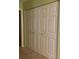 A closet featuring paneled, white, folding doors in a carpeted room, offering ample storage at 4556 Blossom Blvd # B, Zephyrhills, FL 33542