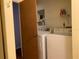 Bright laundry area featuring modern washer, dryer, wire shelving and a door with access to the interior of the home at 4556 Blossom Blvd # B, Zephyrhills, FL 33542
