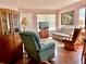Cozy living room with wood floors, a sofa, and a rocking chair at 4556 Blossom Blvd # B, Zephyrhills, FL 33542