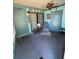 Bright sunroom featuring a cushioned chair, table, ceiling fan, artwork, decor and glass sliding doors at 4556 Blossom Blvd # B, Zephyrhills, FL 33542