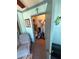 Bright sunroom featuring a cushioned chair, artwork, decor and a closet holding cleaning supplies at 4556 Blossom Blvd # B, Zephyrhills, FL 33542