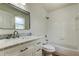 Bathroom featuring white vanity with marble top, shower and bath tub at 476 Denise St, Tarpon Springs, FL 34689