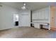 Bedroom view with desk and overhead cabinet storage, plus view to ensuite bathroom at 476 Denise St, Tarpon Springs, FL 34689