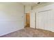 Bedroom view with closet and door that leads to carpeted hallway at 476 Denise St, Tarpon Springs, FL 34689