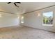 Spacious bedroom with carpet, crown moulding, and abundant natural light from large bright windows at 476 Denise St, Tarpon Springs, FL 34689