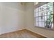 Bright bedroom featuring neutral walls, tile floors, and a large window for natural light at 476 Denise St, Tarpon Springs, FL 34689