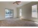 Carpeted bedroom with sliding glass doors leading to backyard pool at 476 Denise St, Tarpon Springs, FL 34689