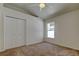 Carpeted bedroom with large closet and window with natural light at 476 Denise St, Tarpon Springs, FL 34689