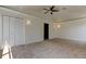 Bright bedroom features plush carpeting, a ceiling fan, and ample closet space at 476 Denise St, Tarpon Springs, FL 34689
