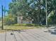 The entryway to Grassy Pointe shows beautiful landscaping around a large sign at 476 Denise St, Tarpon Springs, FL 34689